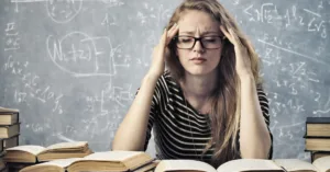 Woman feeling overwhelmed studying with books and notes representing content creation or learning AI tools